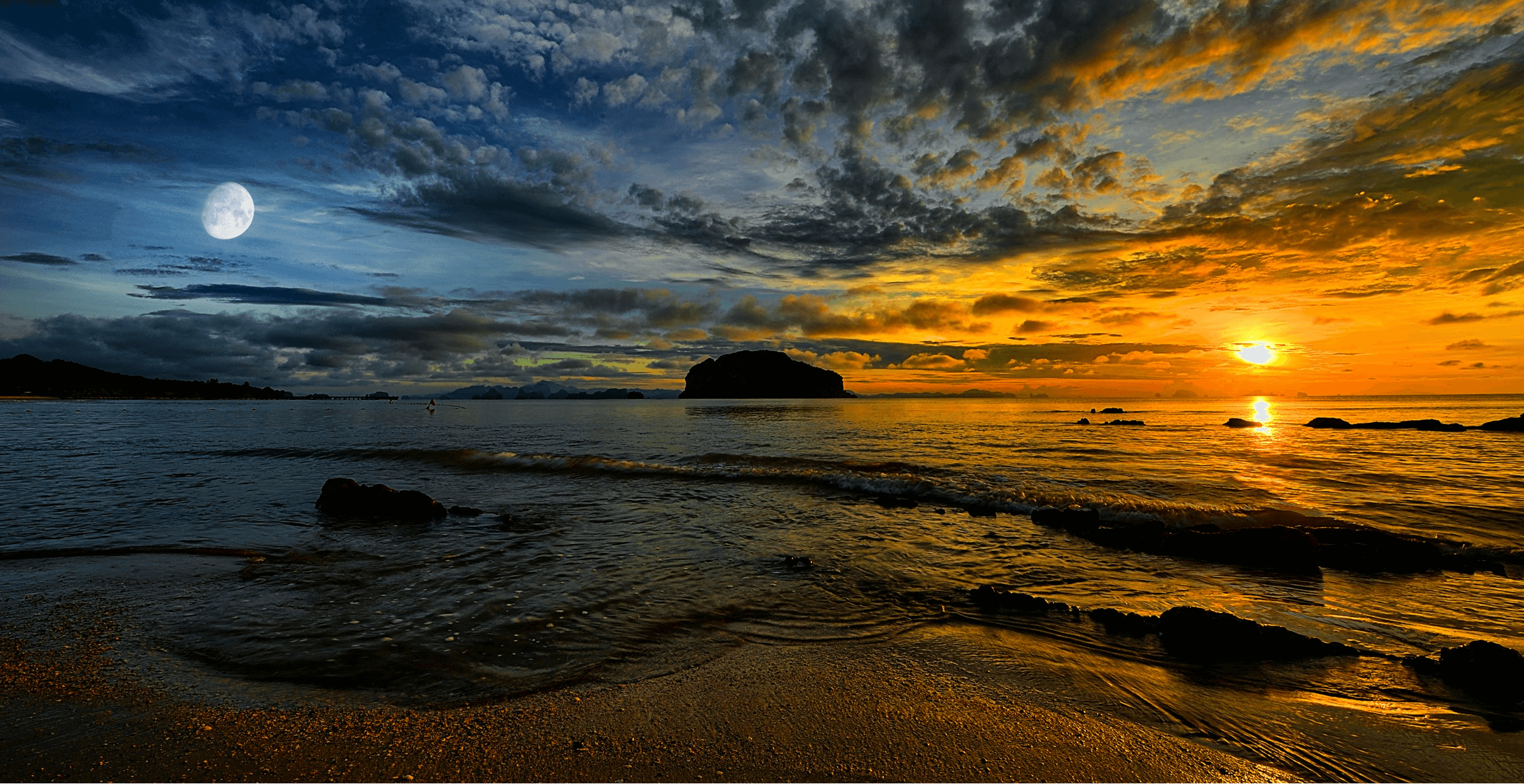 The ocean as seen from a beach, with the sun setting on the horizon and the moon rising in the sky.